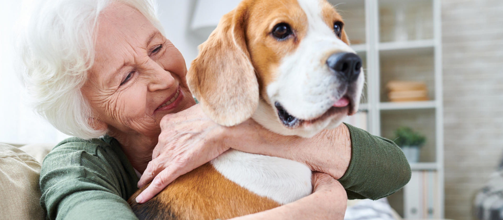 Elderly woman hugging dog