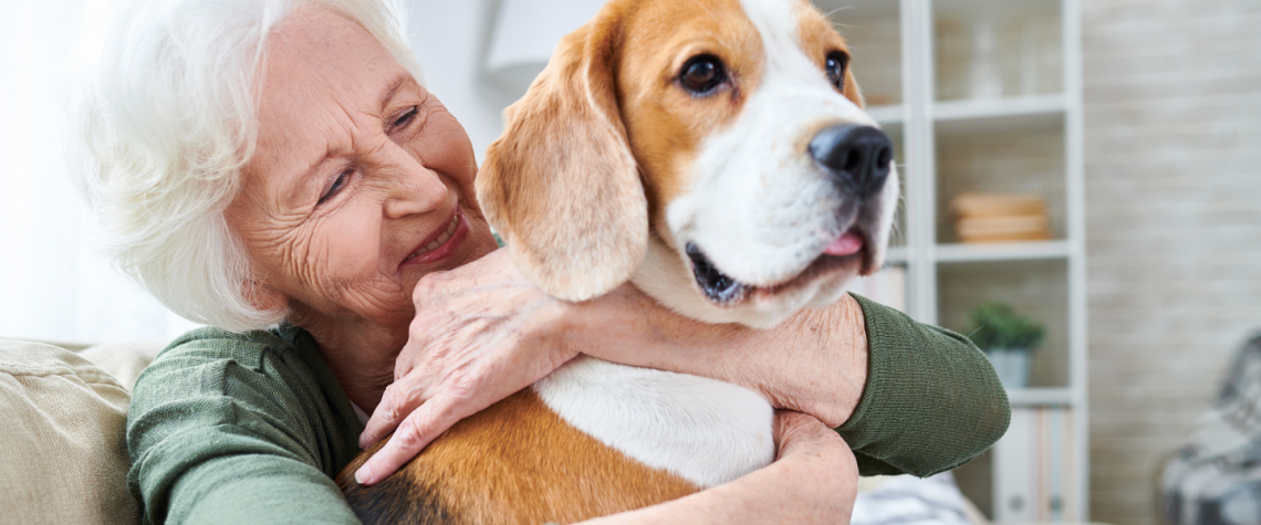 Elderly woman hugging dog