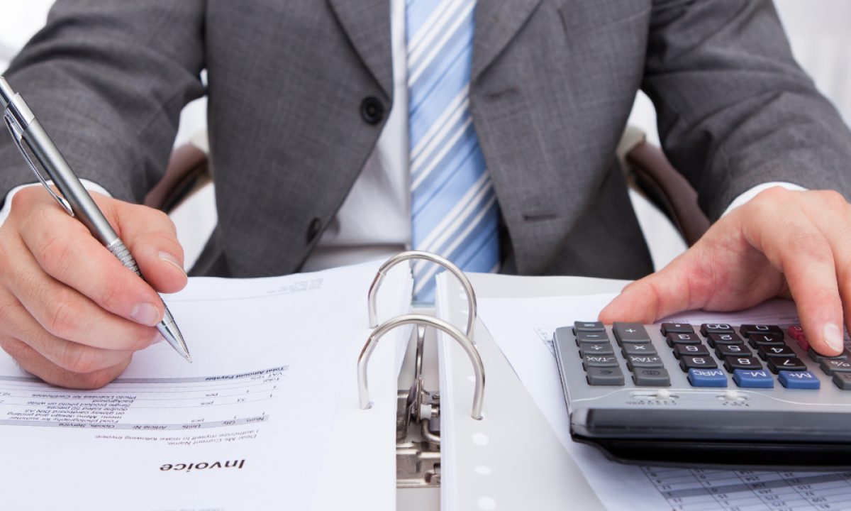 business man filling out payment paperwork